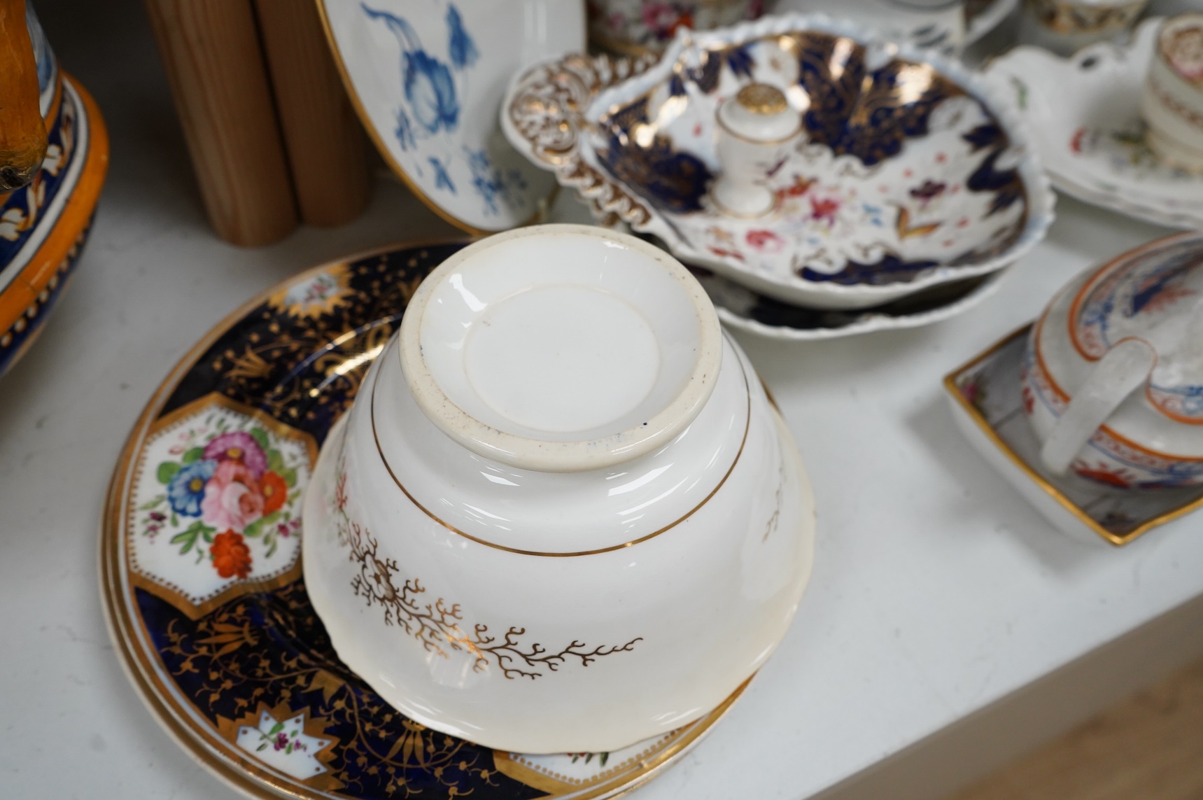 A collection of early 19th century English porcelain tea, dessert and dinner wares including Derby dessert plates, Bloor Derby, Barr Flight & Barr plate, Spode, Coalport etc.